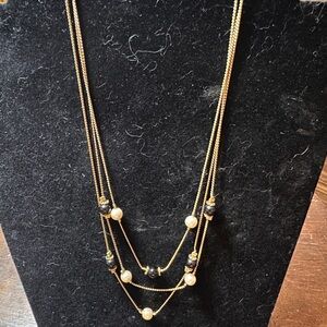 Three stranded, gold tone, pearl, and black glass bead necklace